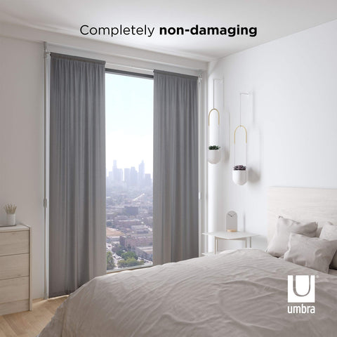 Umbra rod fully extended height showing tall-ceiling adaptability benefit