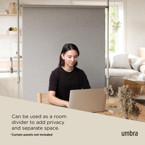 Umbra rod next to person showing adjustable 7–10 ft height