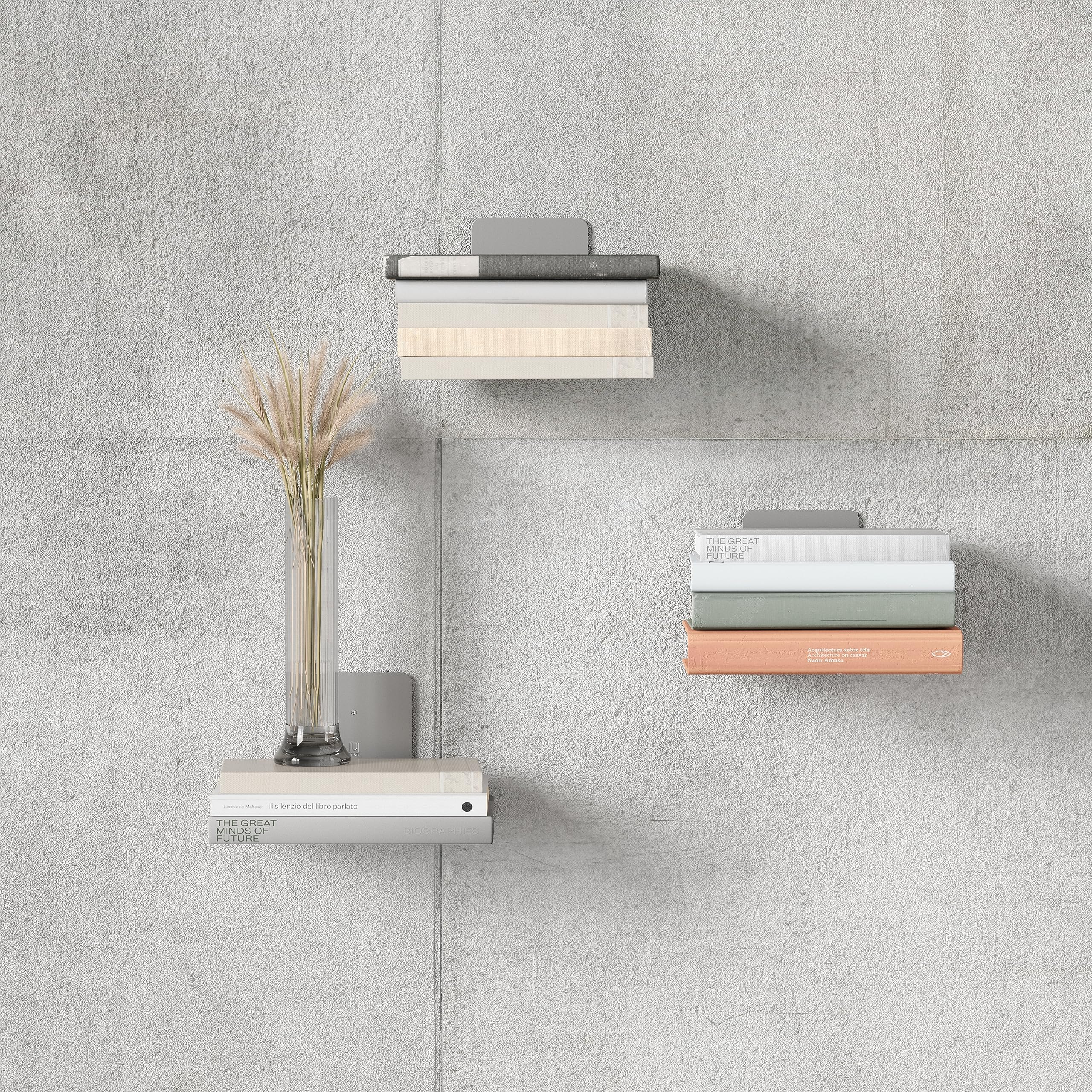 Umbra bookshelf in use with stacked books creating illusion of floating benefit