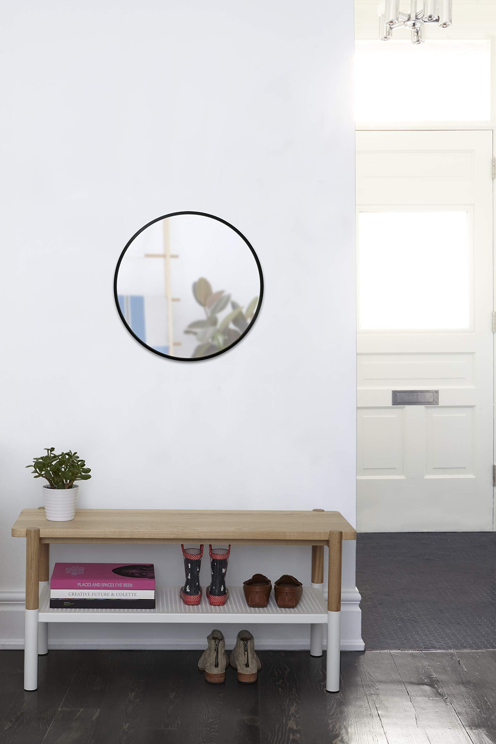 Umbra Hub reflecting natural light in a styled interior to enlarge visual space