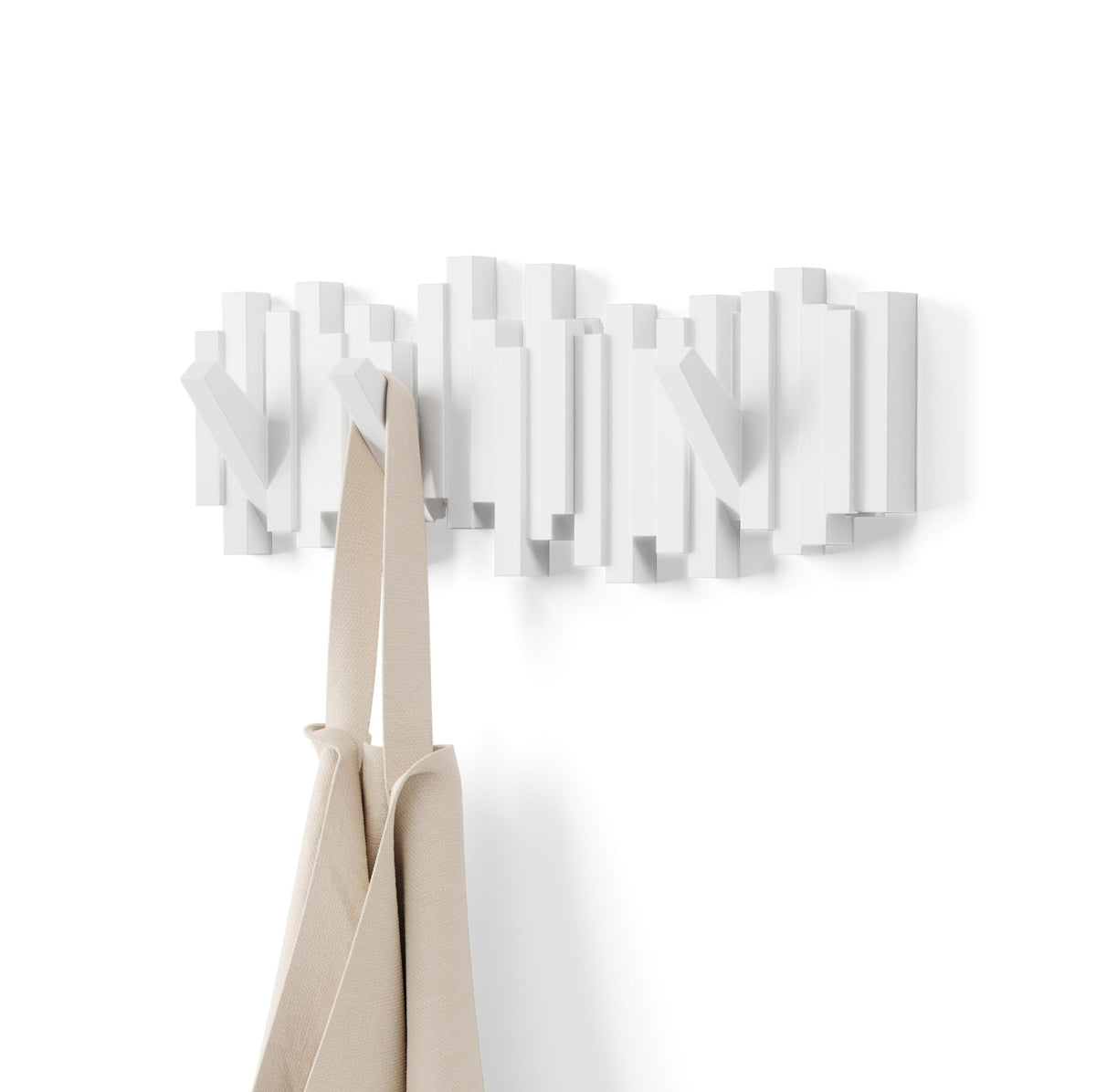 Umbra Sticks front view showing sculptural white design and tidy aesthetic benefit