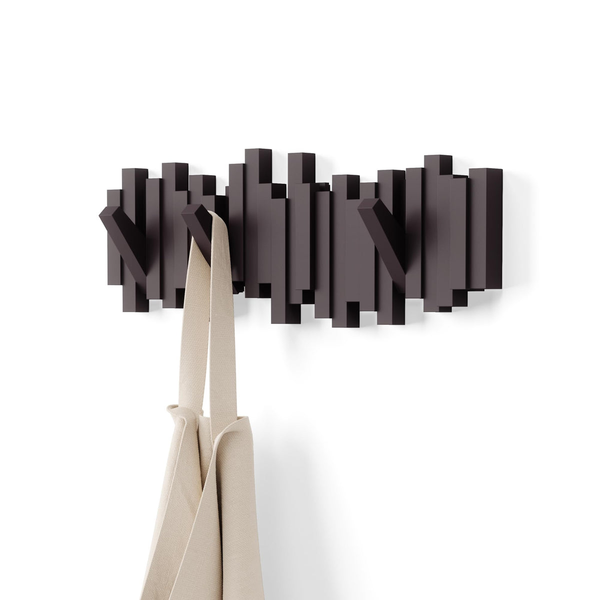 Umbra Sticks front view showing sculptural espresso finish and sleek profile