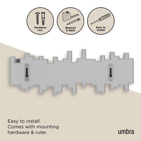 Umbra Sticks holding coats and purses illustrating practical hang space and everyday convenience