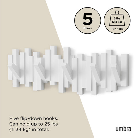 Umbra Sticks holding coats and bags demonstrating practical everyday hanging benefit