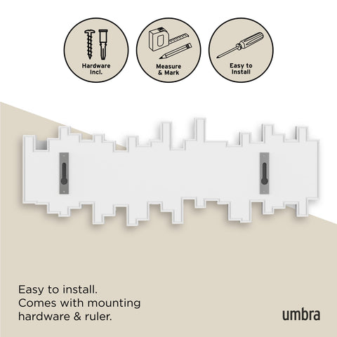 Umbra Sticks next to hand for scale showing compact size and space-saving benefit