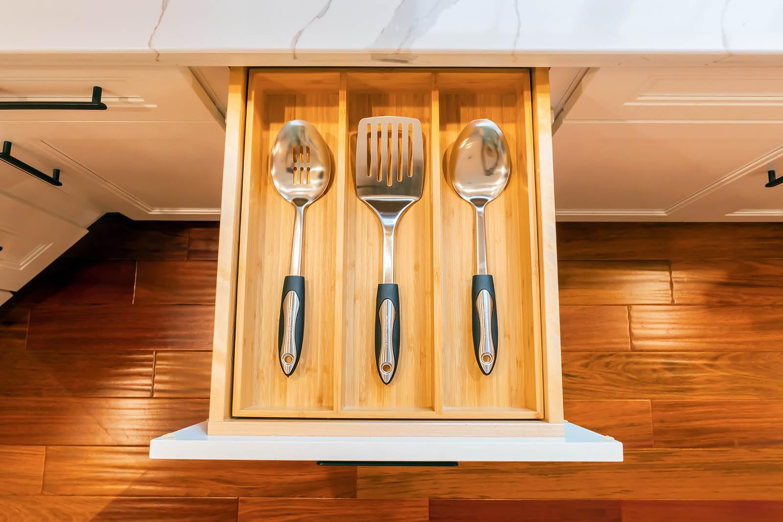 Umilife bamboo organizer placed in a kitchen drawer showing secure fit benefit