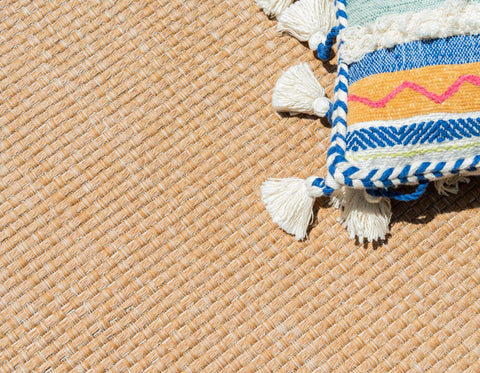 Unique Loom rug placed under outdoor dining set demonstrating protection and definition