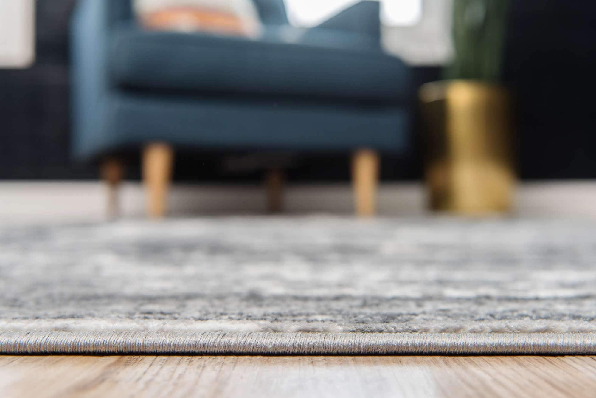 Unique Loom rug under sofa in living room demonstrating cohesive seating area and durability