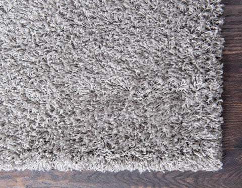 Unique Loom rolled rug image showing how to remove creases and flatten