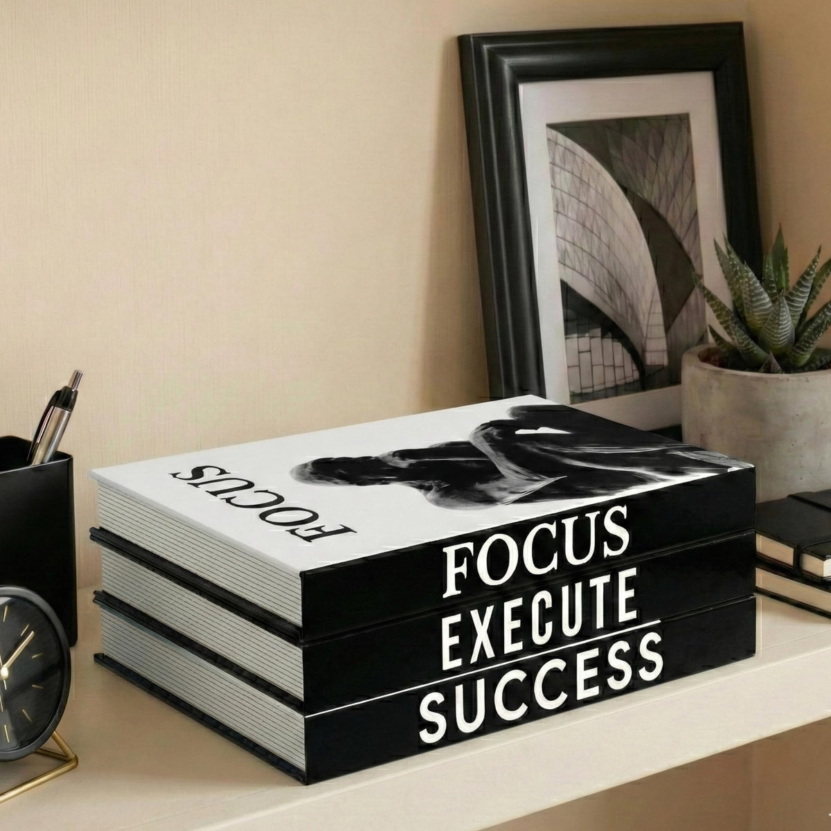 Upstart Decor front view of three faux books showing sleek black and white covers and clean styling benefit