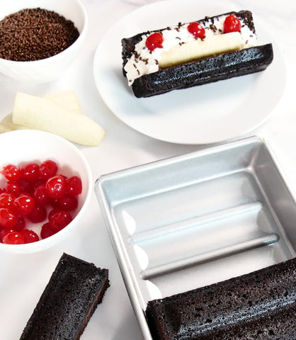 USA Pan in a kitchen setting displaying versatility for rolls, éclairs, and loaves