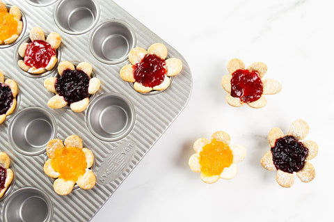 USA Pan pan filled with freshly baked mini muffins demonstrating clean release