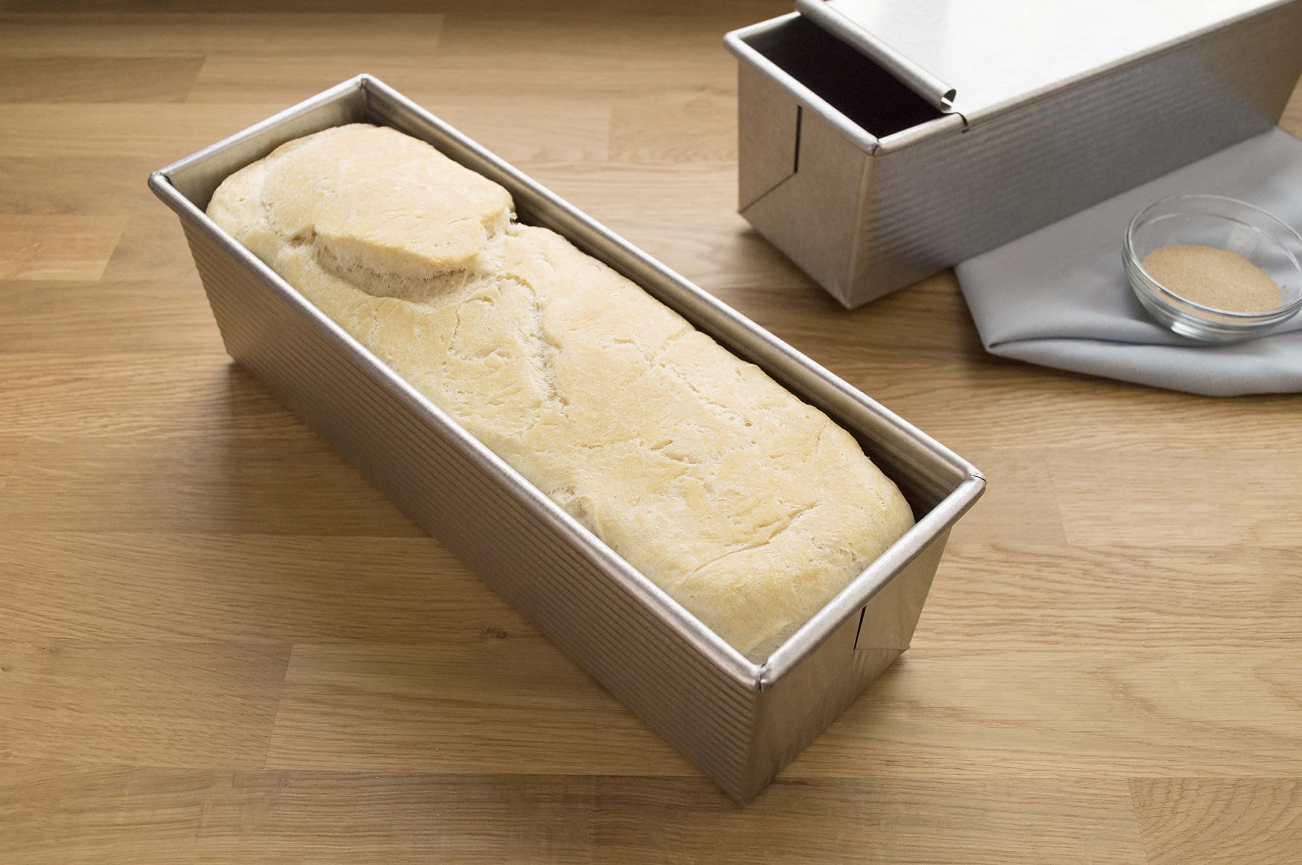 USA Pan pan beside ruler showing 9x4x4 scale for recipe planning and portion control