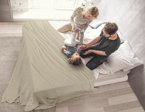 Utopia Bedding folded on a sofa highlighting compact storage and easy living-room layering