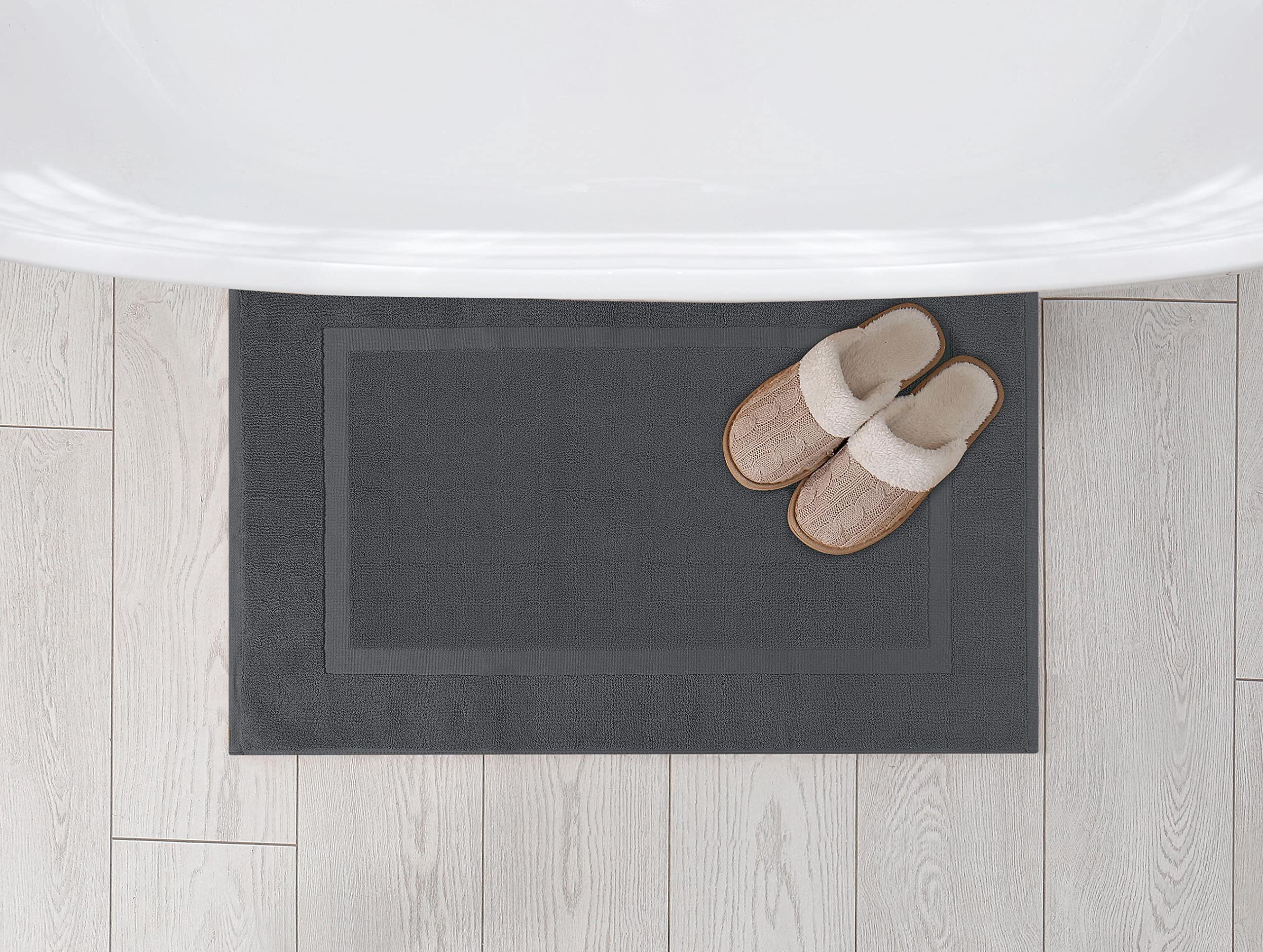 Utopia Towels mat placed by shower demonstrating water control and safer footing