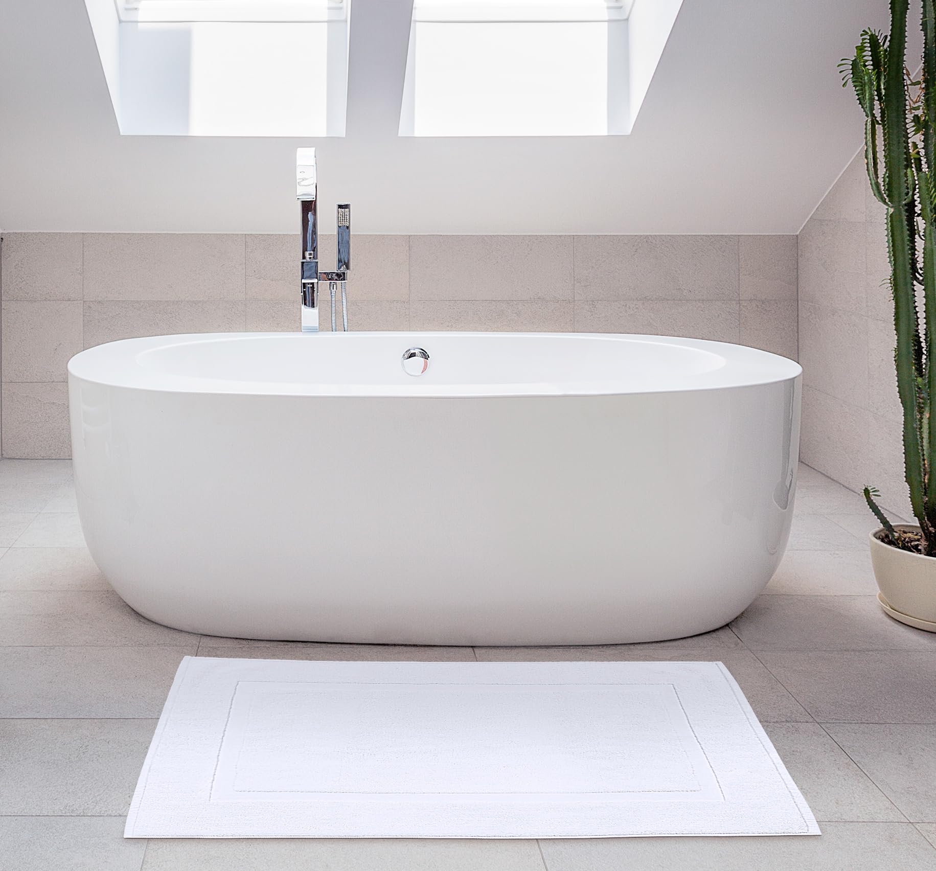 Utopia Towels mat styled with matching towels to illustrate coordinated bathroom look