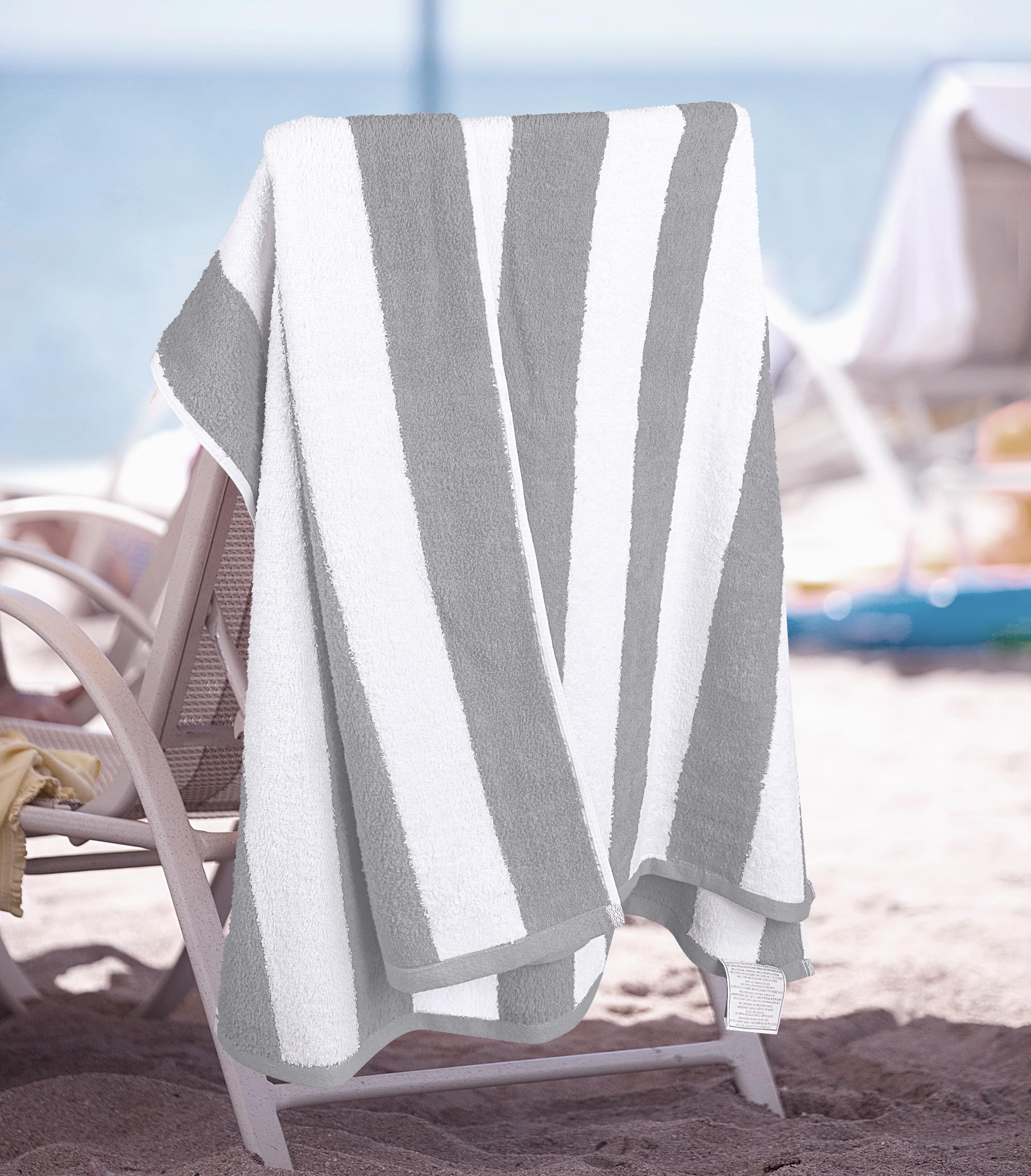 Utopia Towels next to a foot for scale, illustrates generous 30x60 inch size