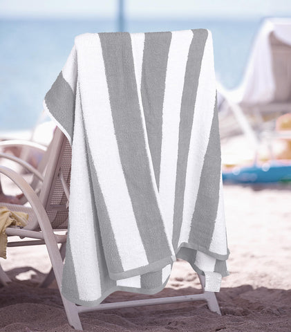Utopia Towels next to a foot for scale, illustrates generous 30x60 inch size