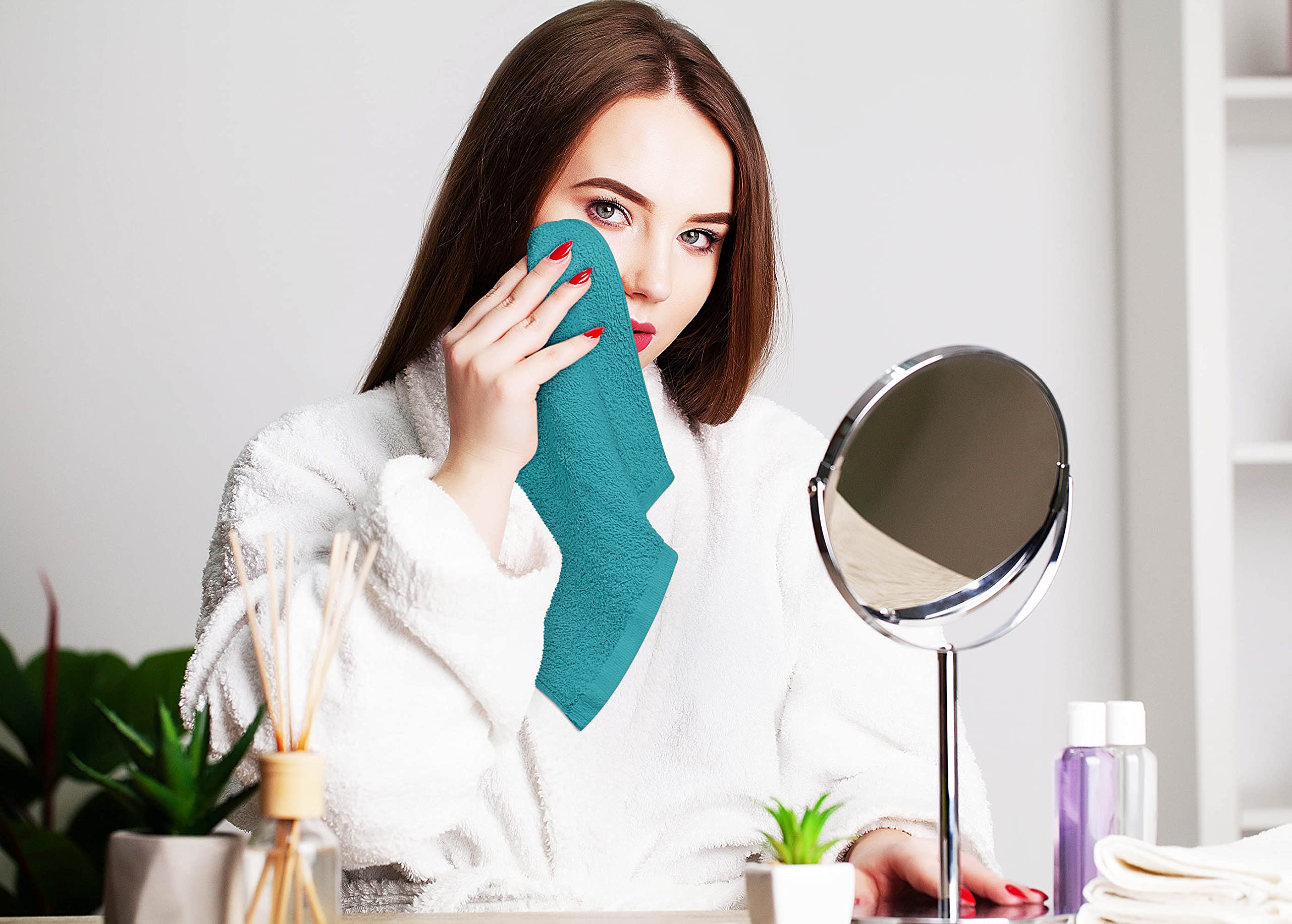 Utopia Towels held in hand illustrating 12x12 size and portable convenience