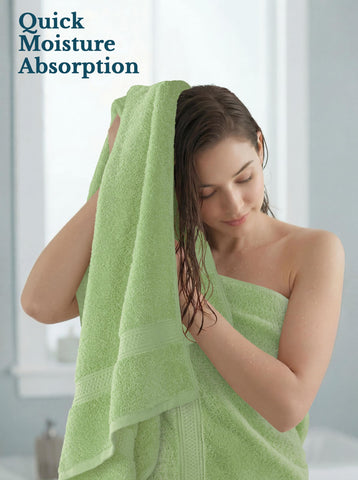 Utopia Towels person drying hair in bathroom illustrating quick moisture pickup