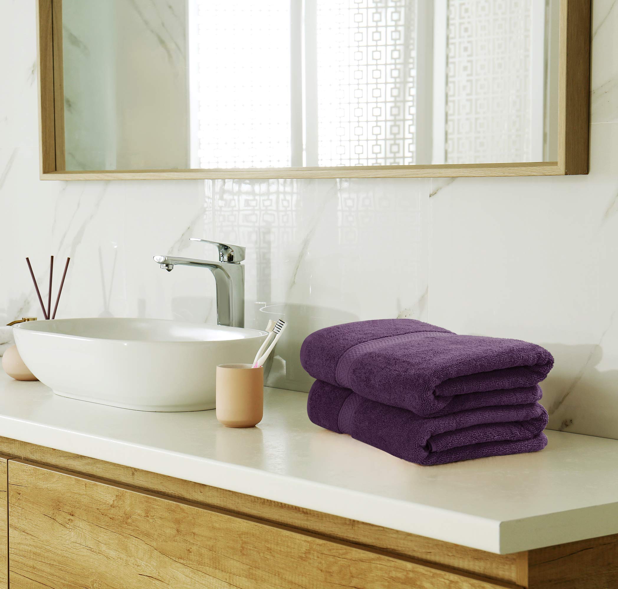 Utopia Towels size comparison beside everyday items showing scale benefit