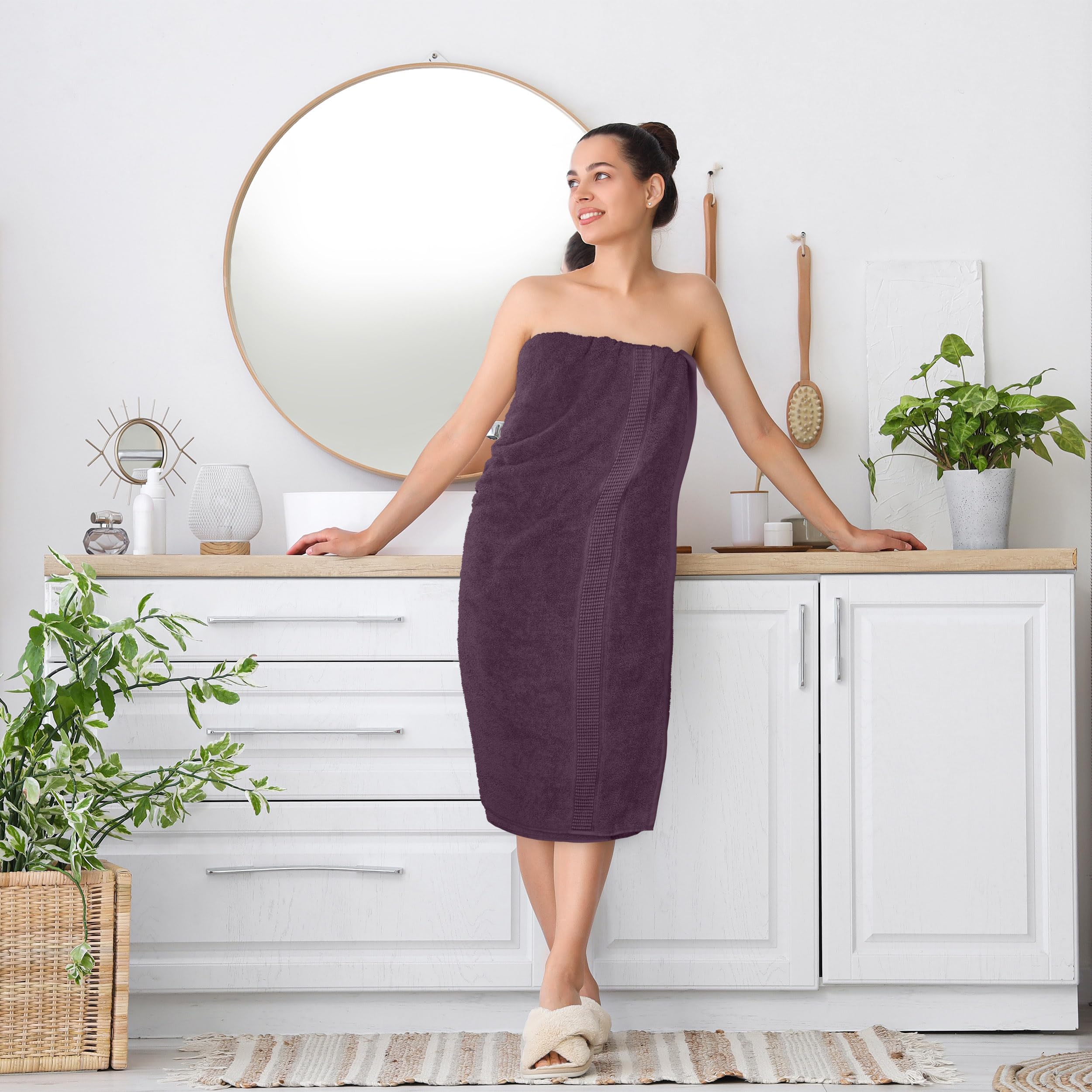 Utopia Towels stacked on bathroom shelf shows tidy storage benefit: decorative accents