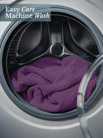 Utopia Towels styled poolside in plum showing versatile outdoor and spa use