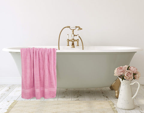 Utopia Towels draped over chair showing size scale and practical benefit