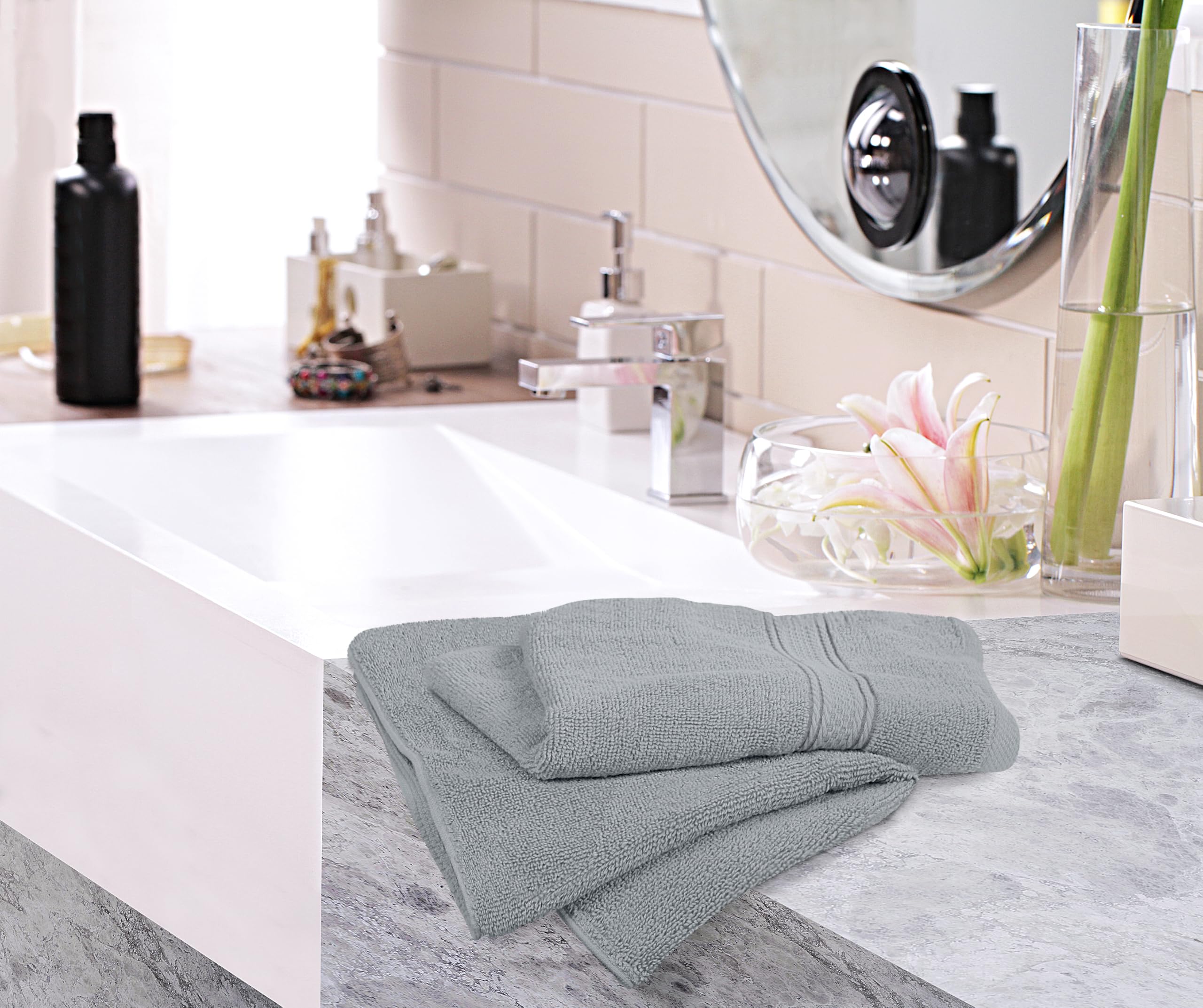 Utopia Towels next to hand for scale illustrating 16x28 inch size and comfortable fit