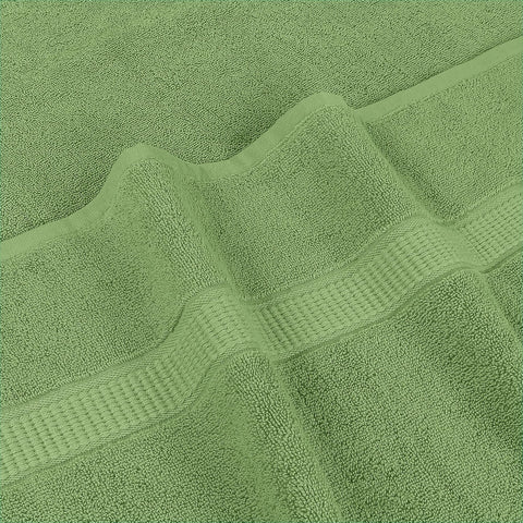 Utopia Towels beside a standard towel illustrating larger 35x70 inch size advantage