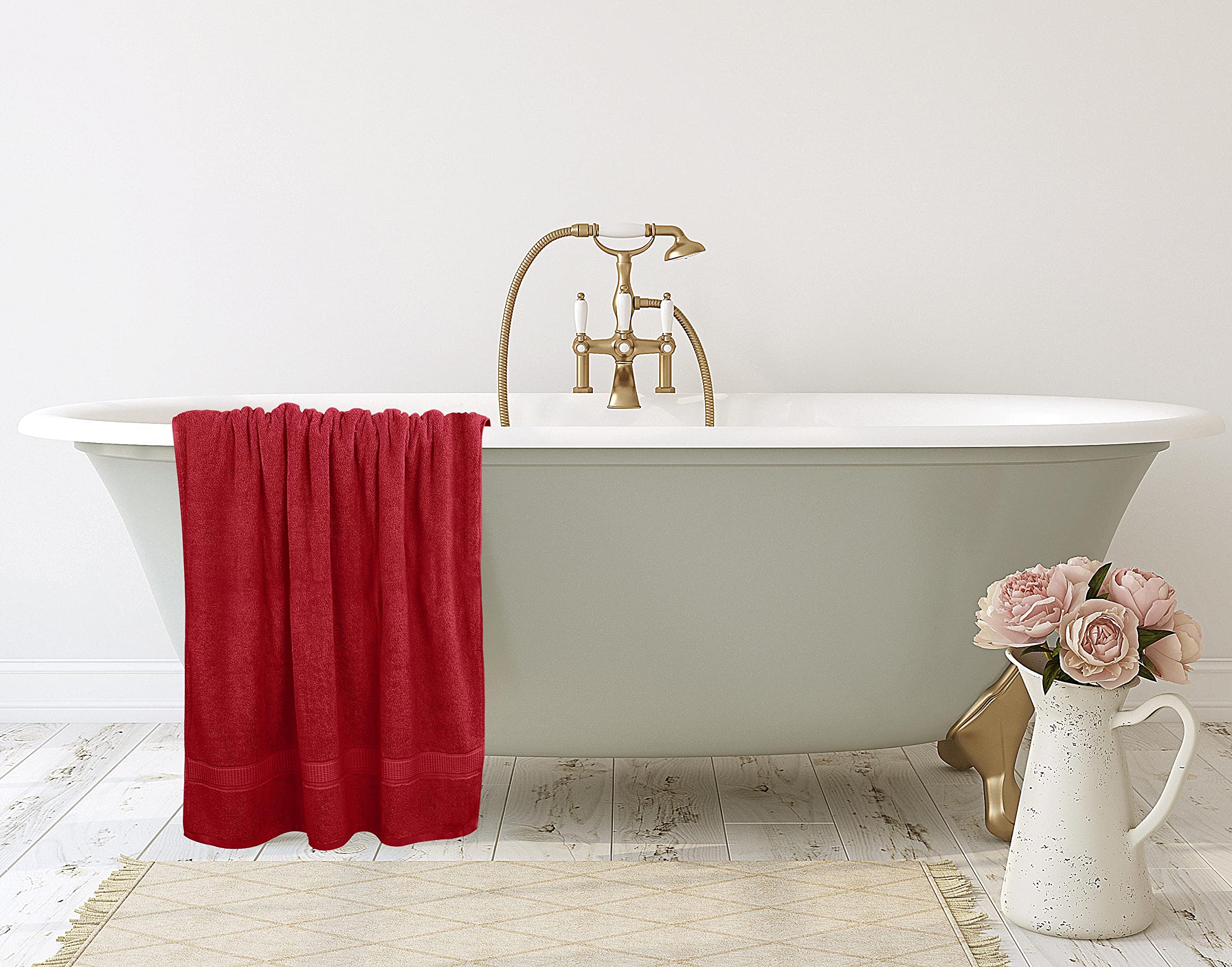 Utopia Towels next to standard towel showing larger 35x70 inch scale