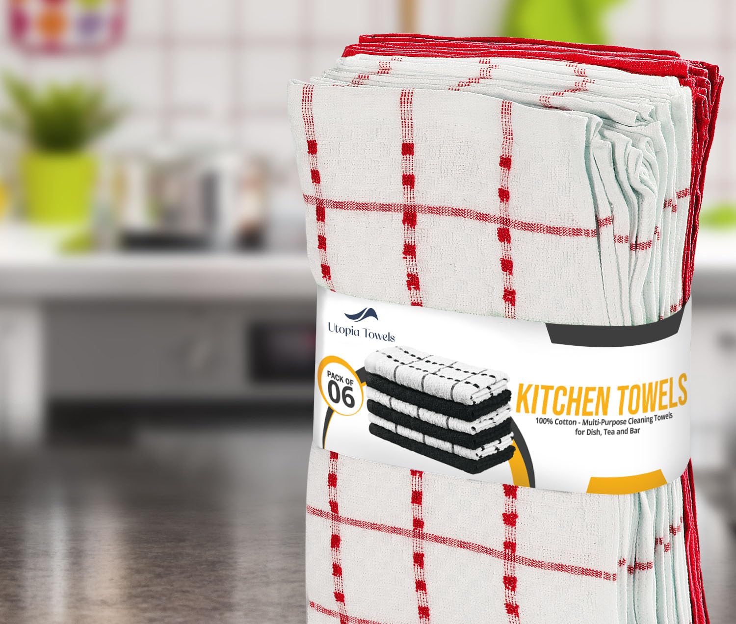 Utopia Towels next to a hand showing 15x25 inch scale and coverage