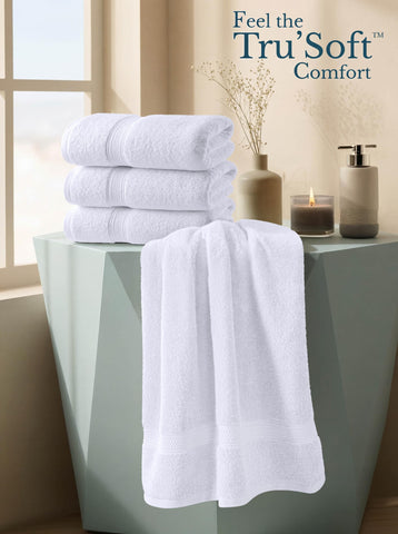 Utopia Towels beside a sheet for size comparison showing 27x54 inch coverage
