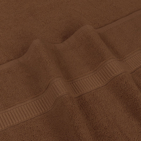 Utopia Towels next to standard towel showing extra 35x70 inch size advantage