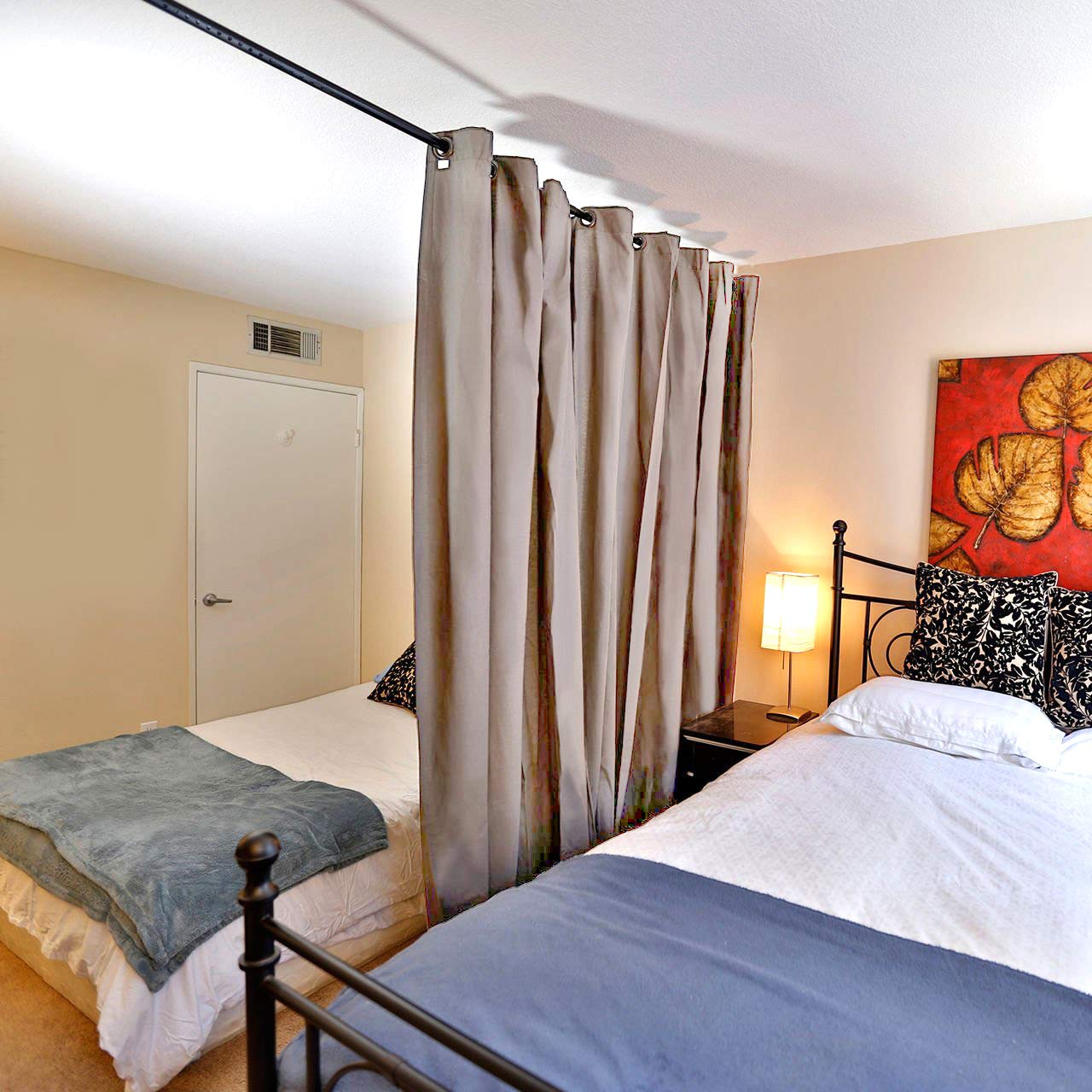 Vailge installed across wide window with curtains, offering instant privacy and light control