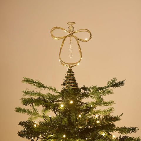 Valery Madelyn angel lit at night on tree creating warm ambient holiday mood