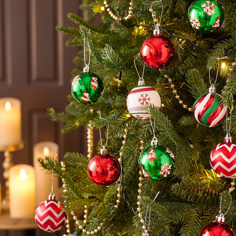 Valery Madelyn close-up of patterned ornaments highlighting stripes snowflakes and "Joy" text for visual interest