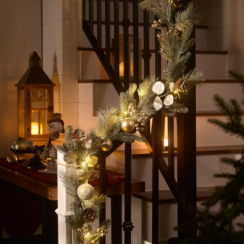 Valery Madelyn garland draped on stairs providing polished holiday atmosphere