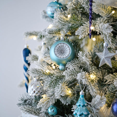 Valery Madelyn ornaments hung on a tree branch showing cohesive look