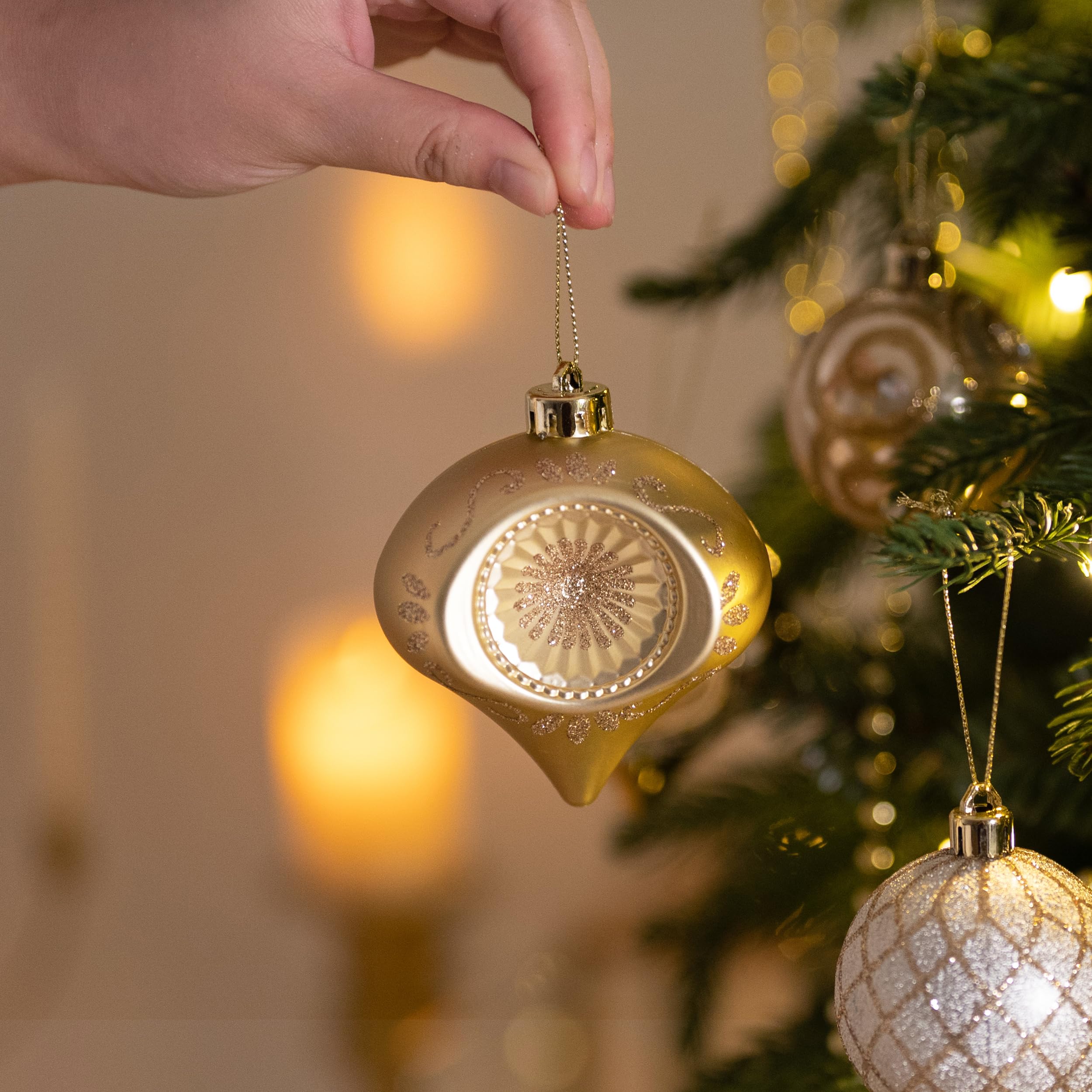Valery Madelyn ornaments in hand showing scale and lightweight, branch-friendly design