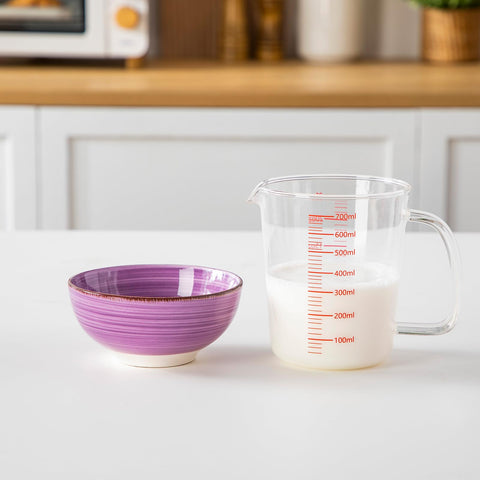 vancasso stacked bowls next to a spoon to show compact size