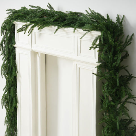 Vemander garland on covered porch highlights sheltered outdoor decorative use