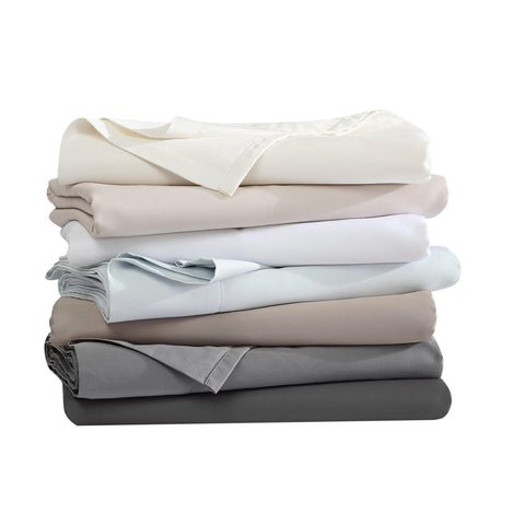 Vera Wang sheets on made bed in bedroom showing refined style and comfort