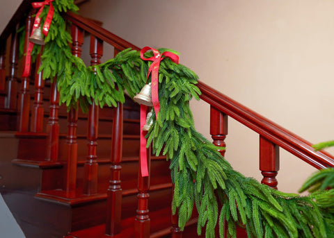 VersaCharm garland wrapped on staircase banister providing easy, secure decoration