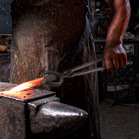 VEVOR tongs in action holding a blade at the forge for precise manipulation