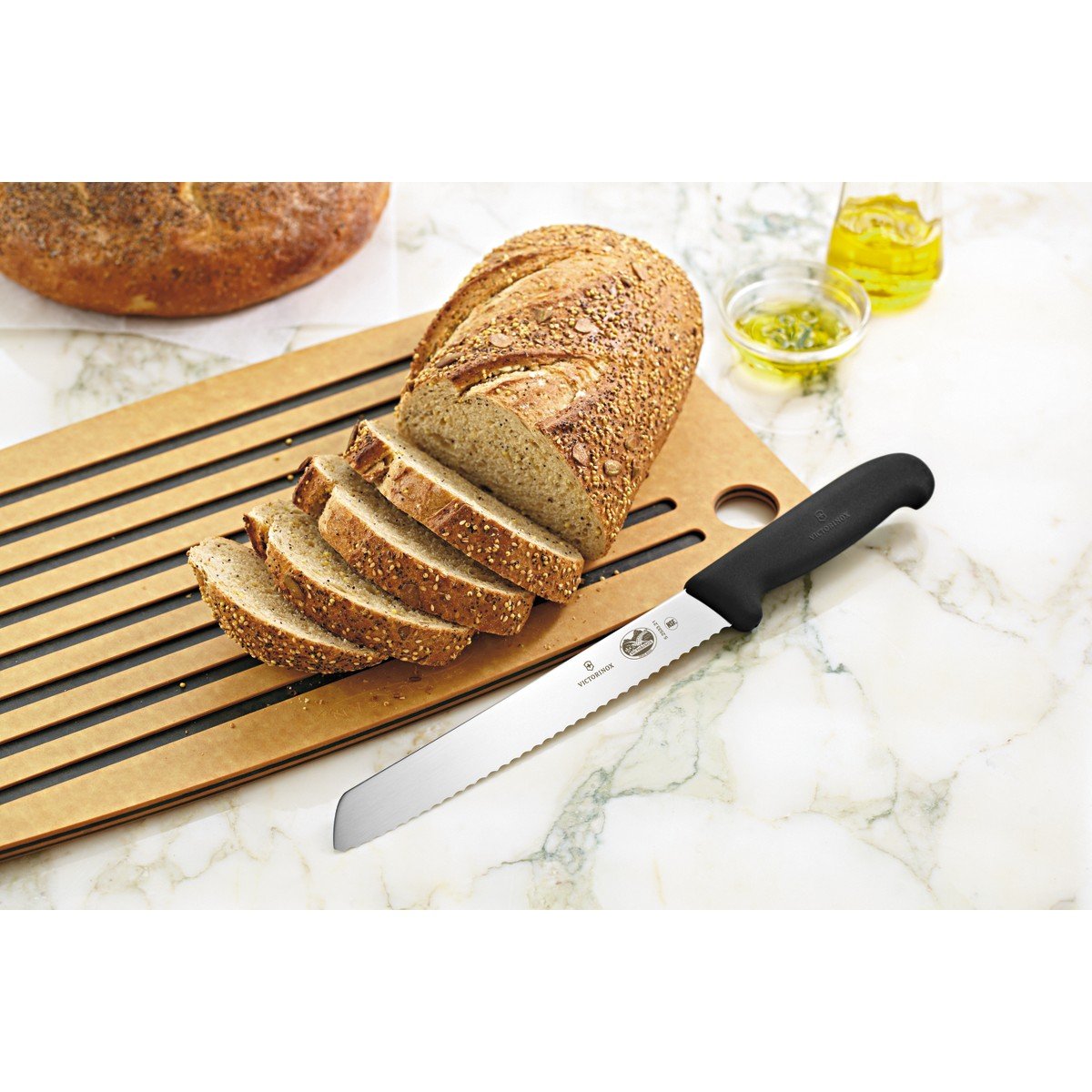 Victorinox slanted hardwood block next to common items showing compact scale saving counter space