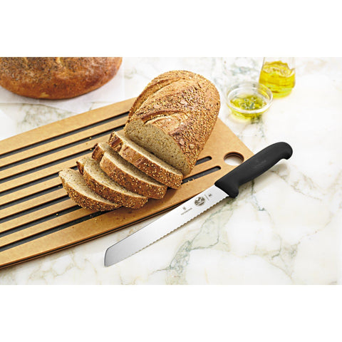 Victorinox slanted hardwood block next to common items showing compact scale saving counter space