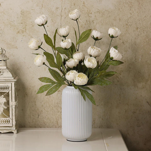 VIERENA peony stems in tall vase adding height and lasting elegance to room