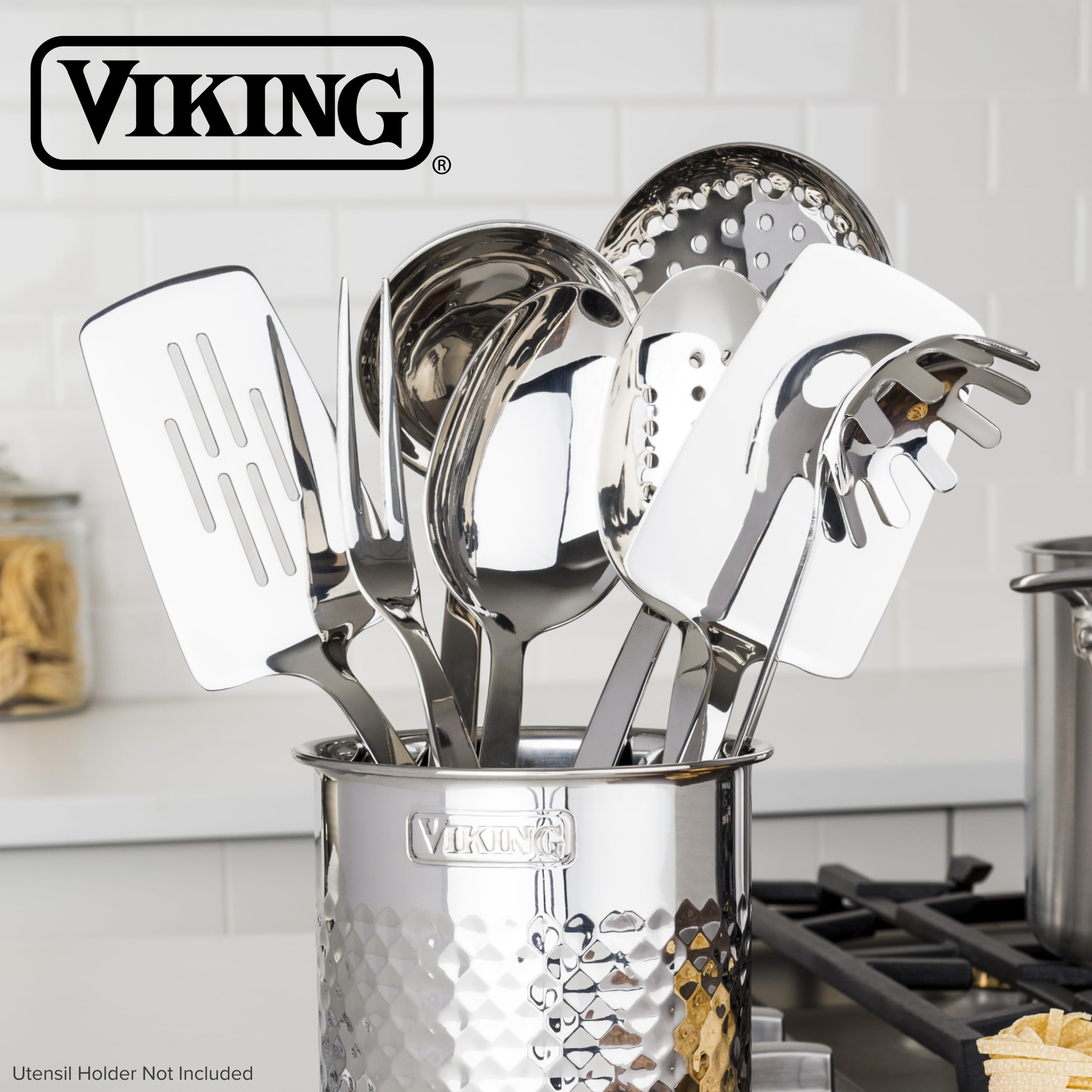Viking utensils next to a spoon and pan to show scale and practical kitchen fit