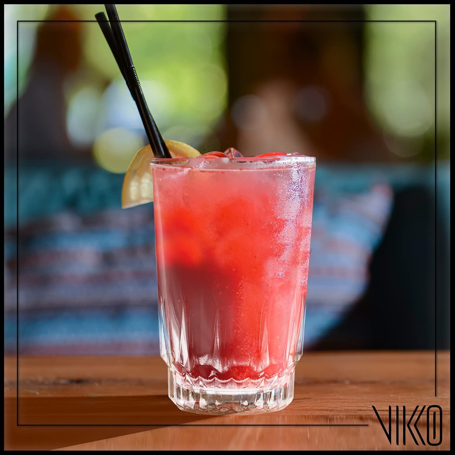 Vikko glass in child's hand with juice demonstrating safe small portion use.
